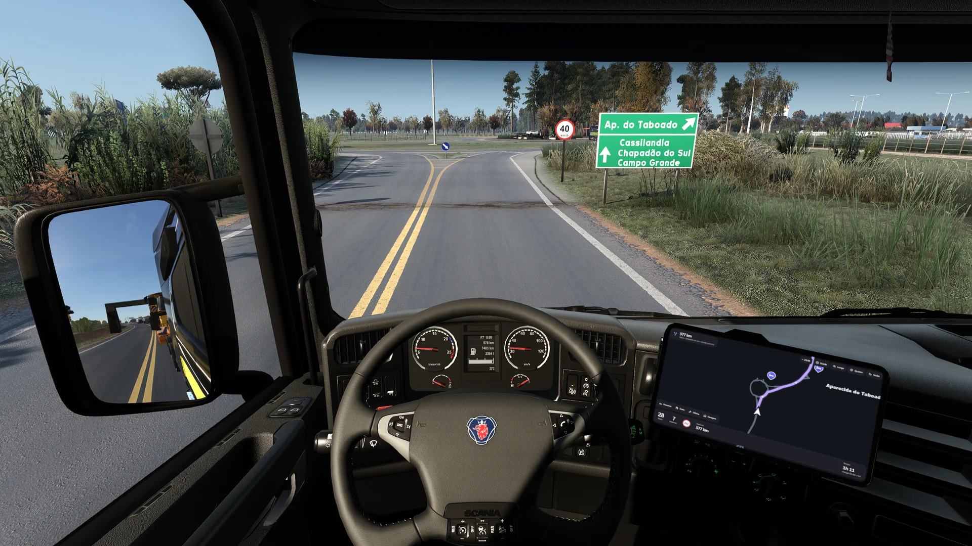 EuroOs no tablet de uma cabine Scania, com o GPS ao lado do volante e a estrada do mapa RBR à frente
